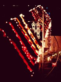 Low angle view of illuminated lanterns at night