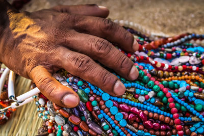 Close-up of man selling jewelry outdoors