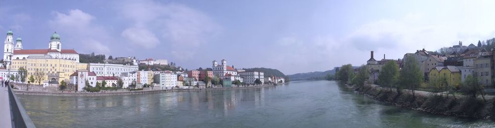 Panoramic view of river amidst buildings against sky