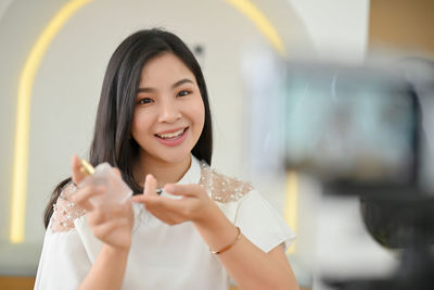 Portrait of young woman standing outdoors