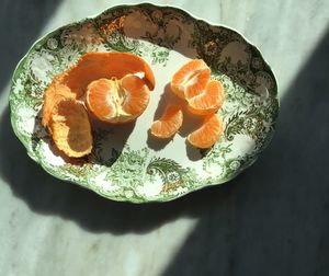 Close-up of peeled orange on plate