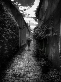 People walking on house against sky