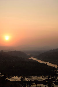 High angle view of silhouette landscape against sky during sunset