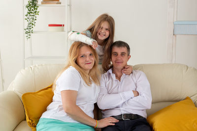 Portrait of smiling woman sitting at home