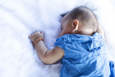 Newborn baby boy portrait on white carpet closeup. motherhood and new life concept