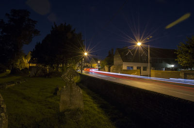 Illuminated city against sky at night