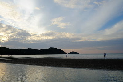 Scenic view of beach against sky during sunset