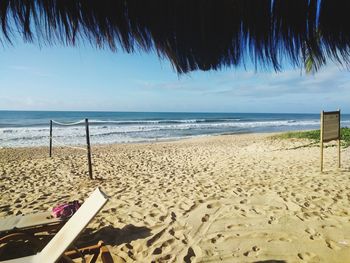 Scenic view of beach against sky on sunny day