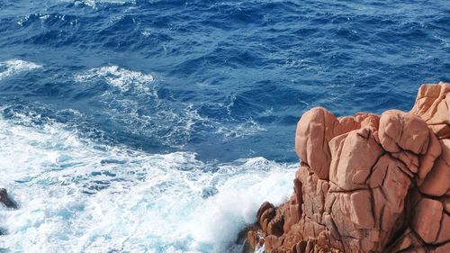 High angle view of rock formations at seashore