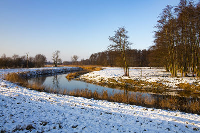 Snow covered field against sky