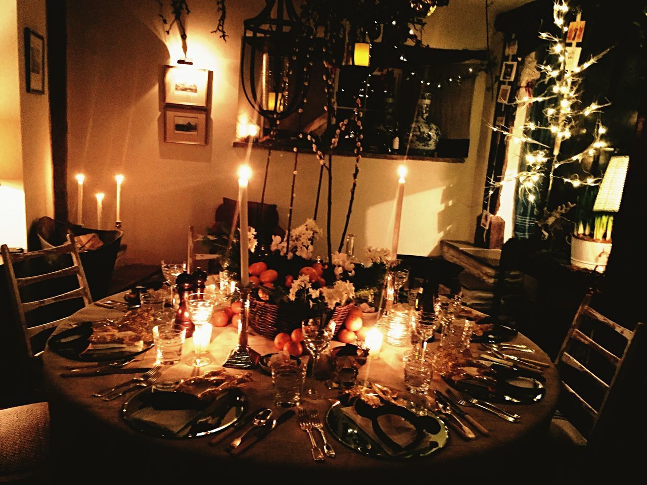 ILLUMINATED CANDLES ON TABLE AT RESTAURANT