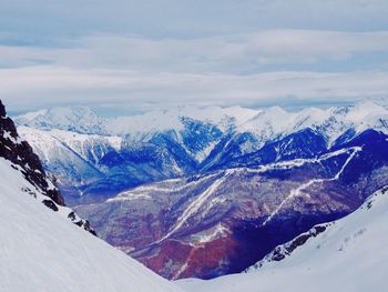 Scenic view of snow covered mountains against sky