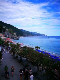 People on beach against sky