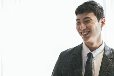 Portrait of young man against white background