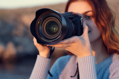 Portrait of woman photographing