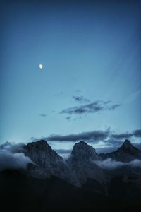 Scenic view of mountains against blue sky