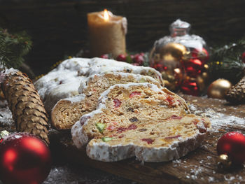 Traditional christmas stollen, cones, branches of a tree and christmas decorations, pastry dessert