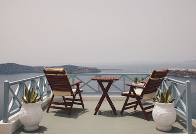 Empty chairs and tables at seaside