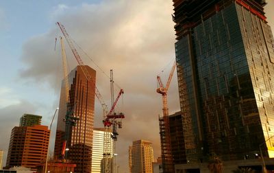 Low angle view of skyscrapers against sky during sunset