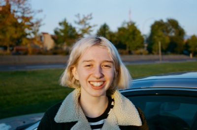 Portrait of young woman against trees