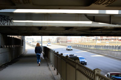 Person walking under elevated road