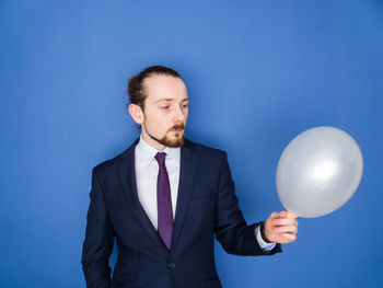 Portrait of a man against blue background