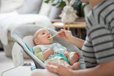 Close-up of baby boy lying on bed at home