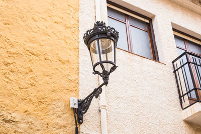 Low angle view of street light against building