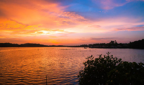 Scenic view of lake against orange sky