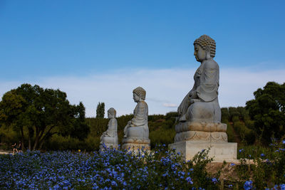 Statue of buddha against trees