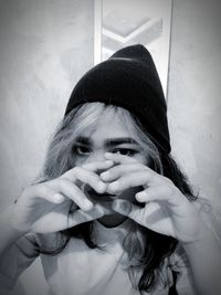 Portrait of woman wearing hat at home