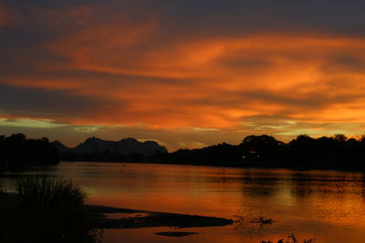 Scenic view of lake against orange sky