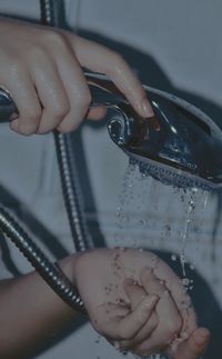 Close-up of woman using shower