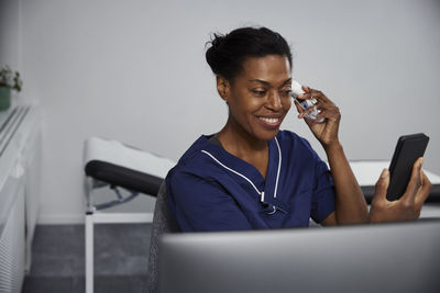 Female doctor having online consultation on smart phone