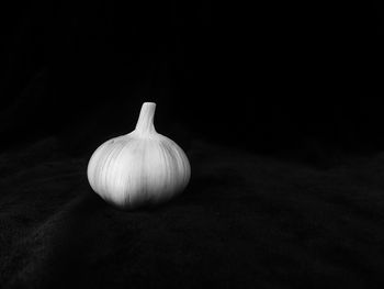 Close-up of apple on table against black background