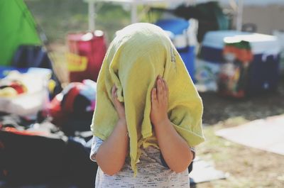 Close-up of child covering her head