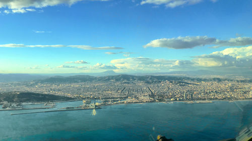 High angle view of city against cloudy sky