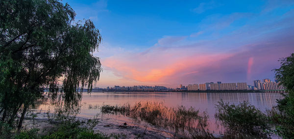 Scenic view of lake against sky during sunset