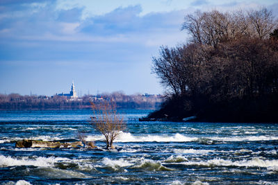 Scenic view of lake against sky during winter