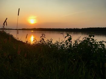 Scenic view of lake against sky during sunset