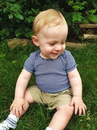 Baby boy sitting on grass