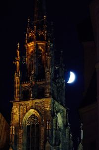 Low angle view of illuminated cathedral against sky at night