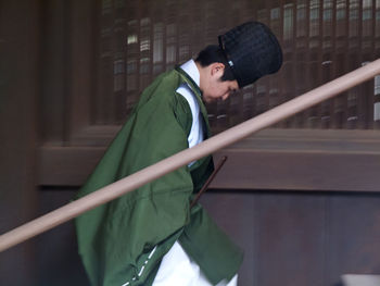 Side view of young man standing outdoors