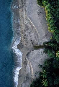 High angle view of surf on sea shore