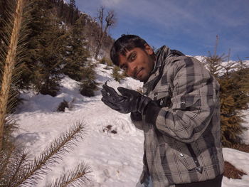 Portrait of man with ice cream in winter