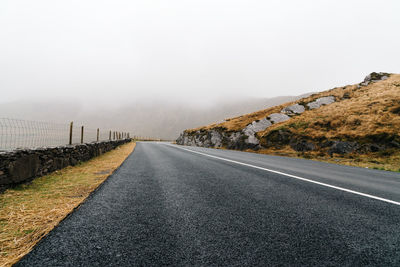 Misty lonely road in the wild atlantic way of ireland