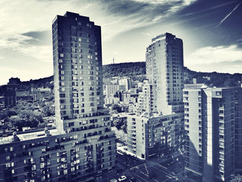 Cityscape against cloudy sky