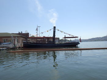 Ship moored in sea against sky