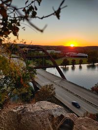 High angle view of bridge over river against sky at sunset