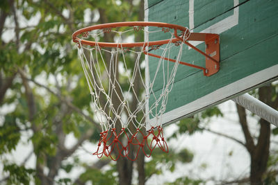 Low angle view of basketball hoop against trees